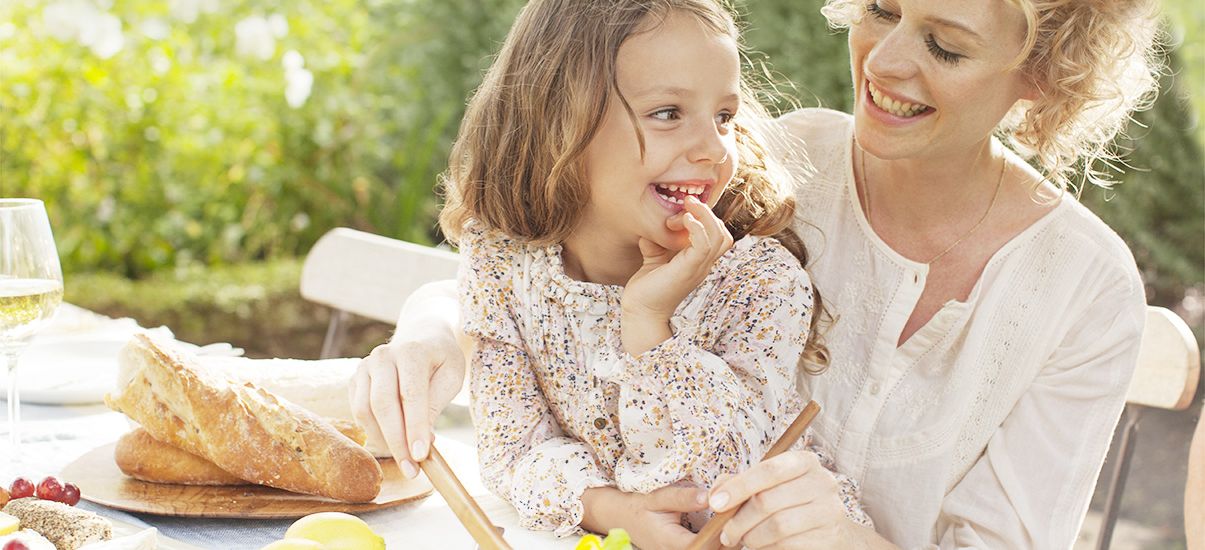 La madre e la figlia godono di un'insalata estiva