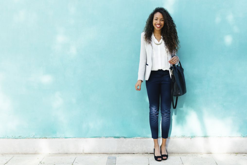 Frau vor blauer Wand mit Taschen